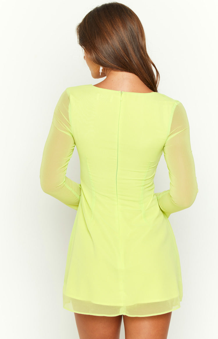 Rear view of a lime long sleeve mini dress with an invisible back zipper and sheer overlay fabric