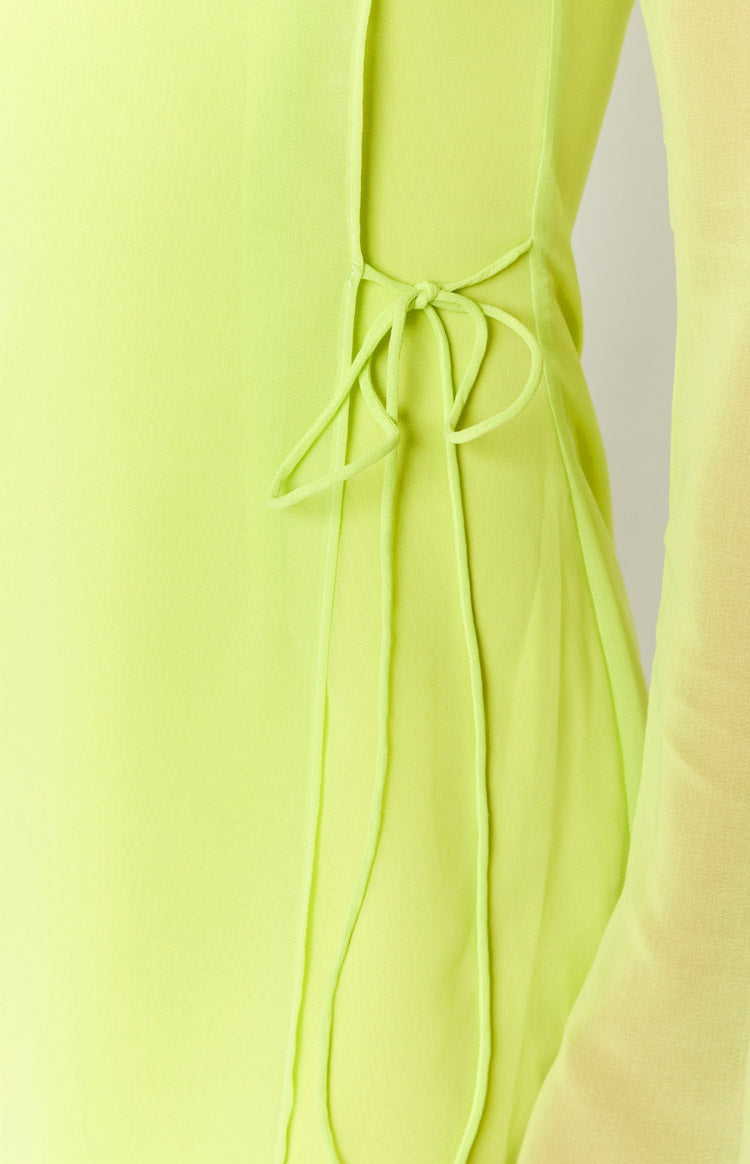 Close-up of the knotted side tie detail on a sheer lime green mini dress