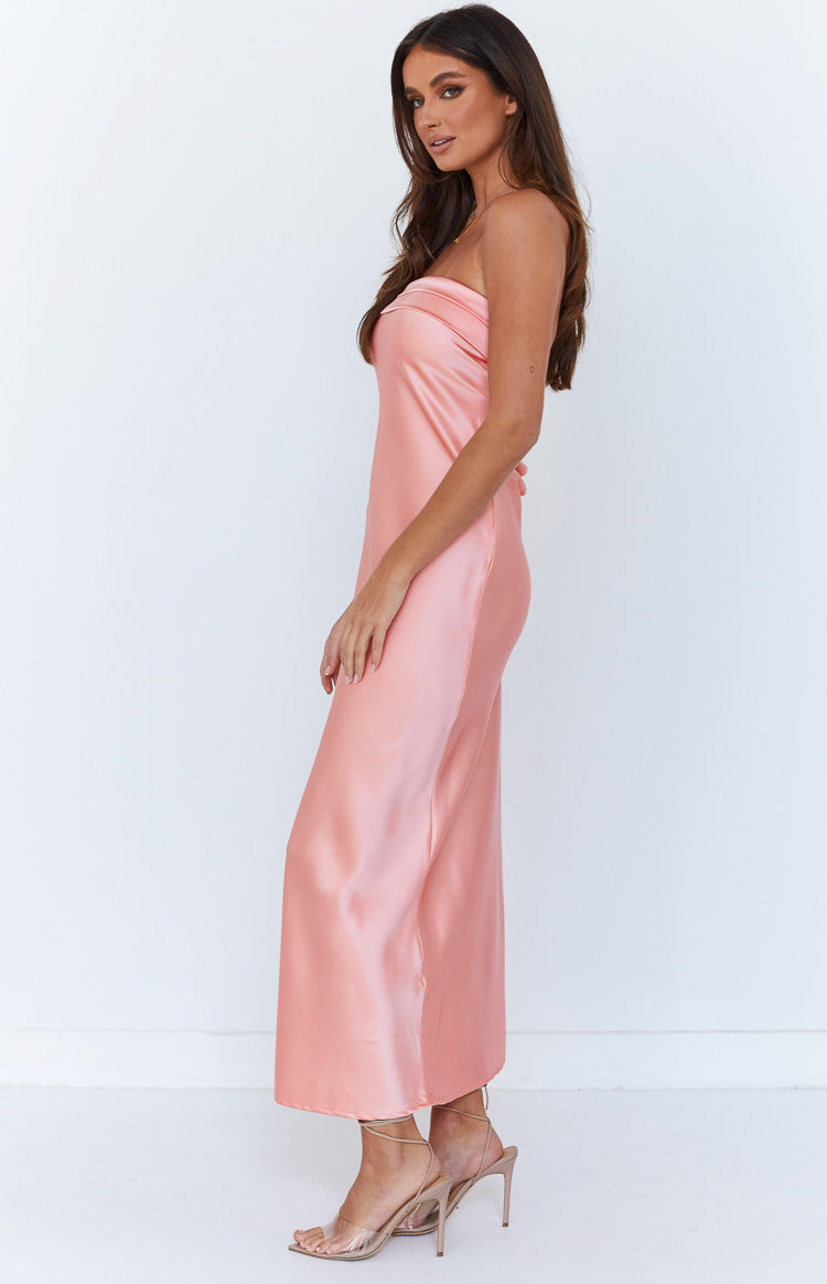 Side view of a pink satin strapless maxi dress with a relaxed fit and flowy drape