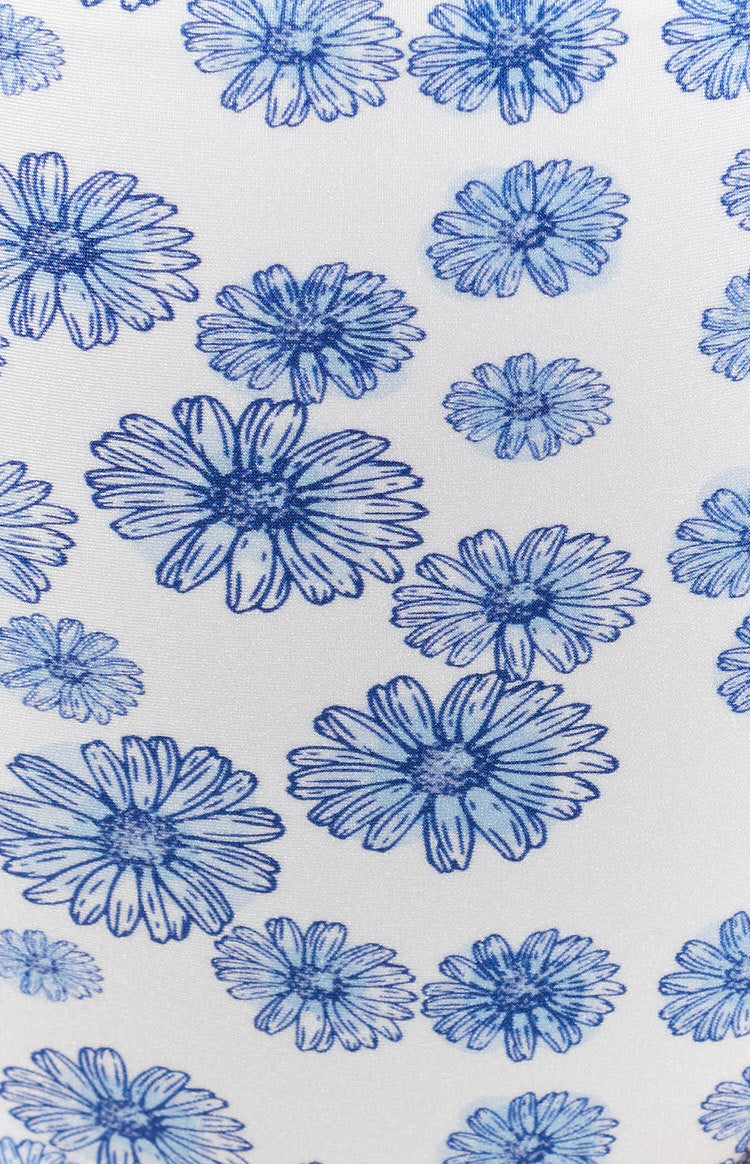 White swimwear fabric with a blue daisy print, featuring sketched flowers in varying sizes and shades of blue