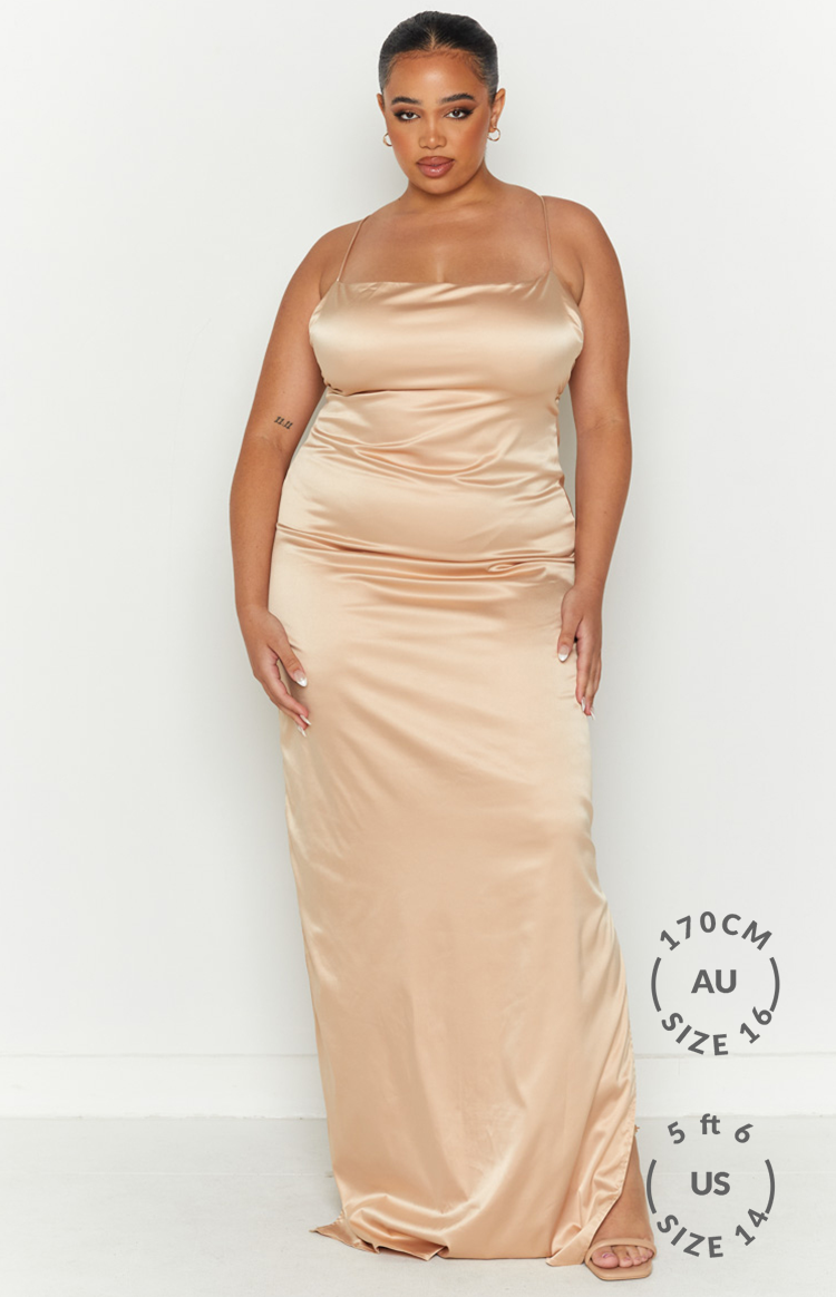 Champagne satin maxi dress with a cowl neckline and delicate spaghetti straps, flowing silhouette