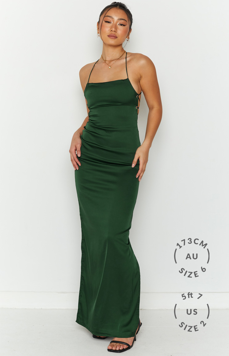 Emerald green satin maxi dress with a straight neckline, thin straps, and lace-up side detail