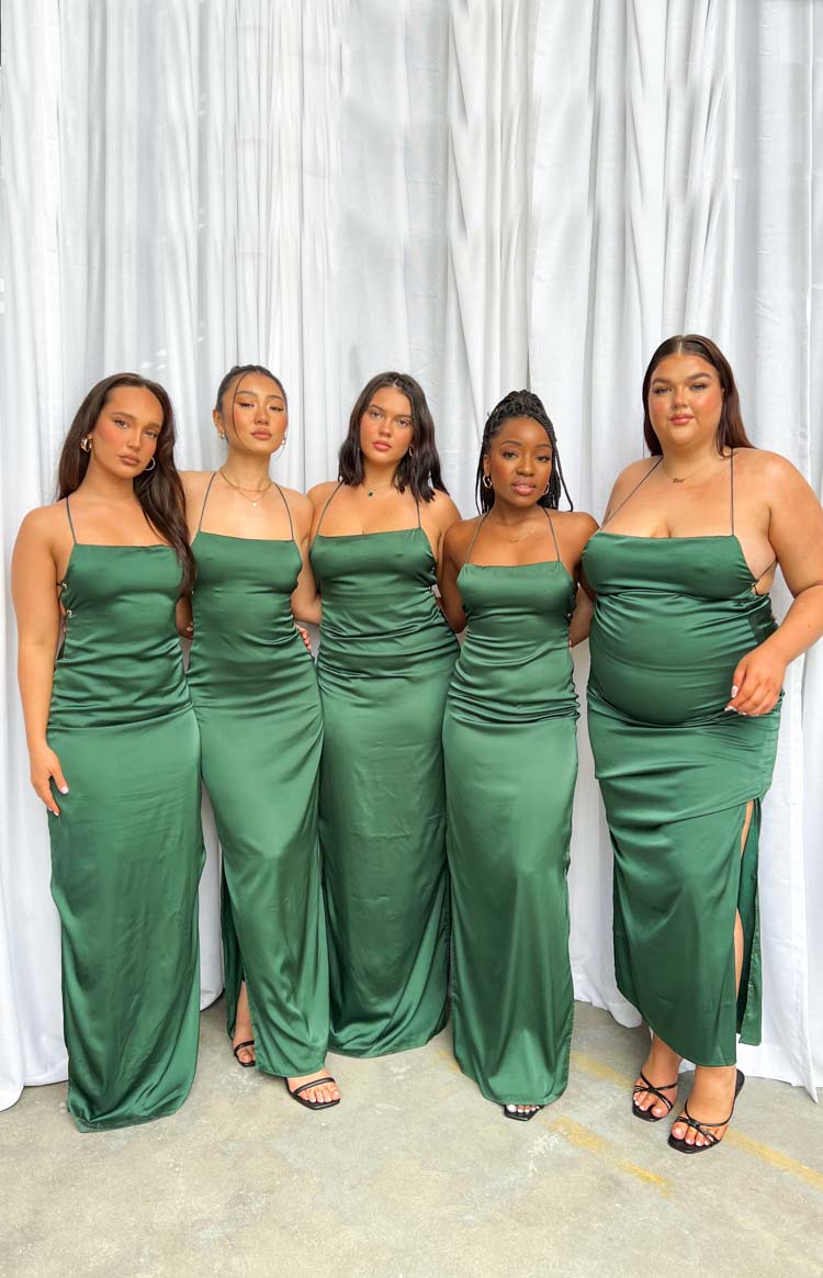 Flowing emerald green satin maxi dress with a straight neckline, thin straps, and a side split