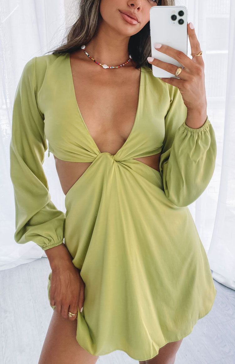 Deep V-neck lime green mini dress featuring a twisted front, side waist cutouts, and long elasticated sleeves