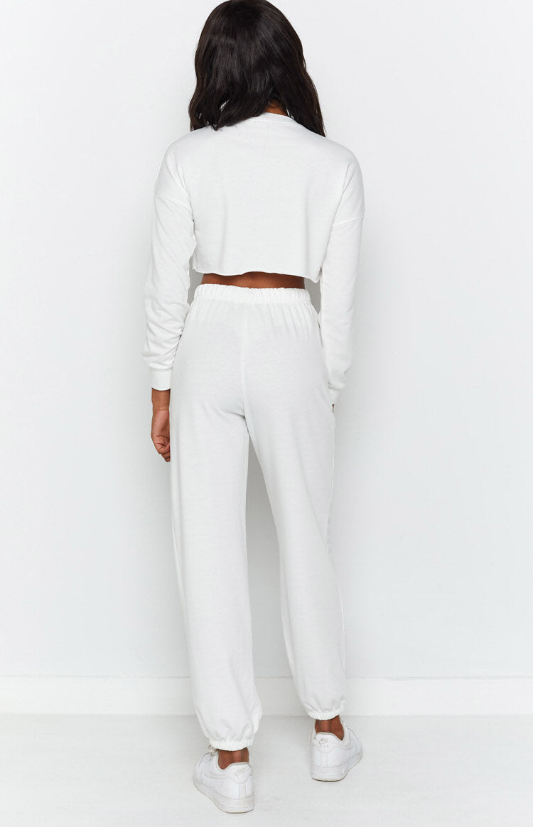 Relaxed fit white long sleeve cropped sweatshirt with crew neck and matching joggers with elasticated cuffs