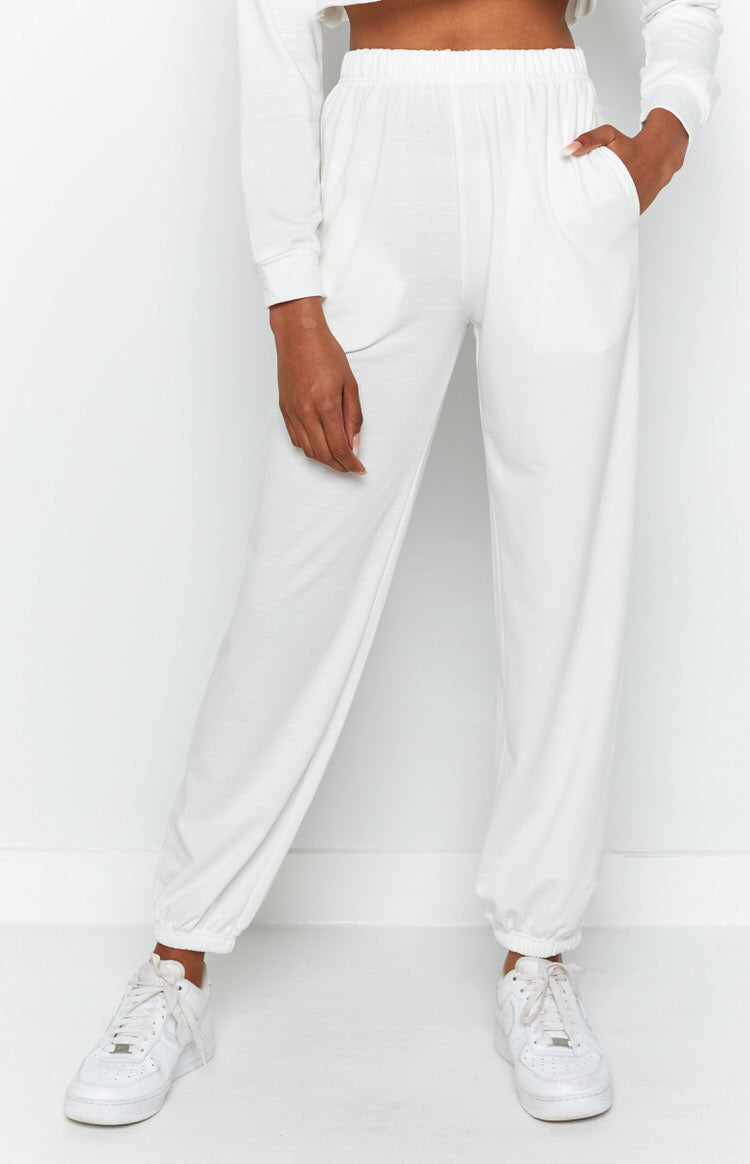 White soft jersey lounge pants with an elasticated high waist, side pockets, and cuffed ankles