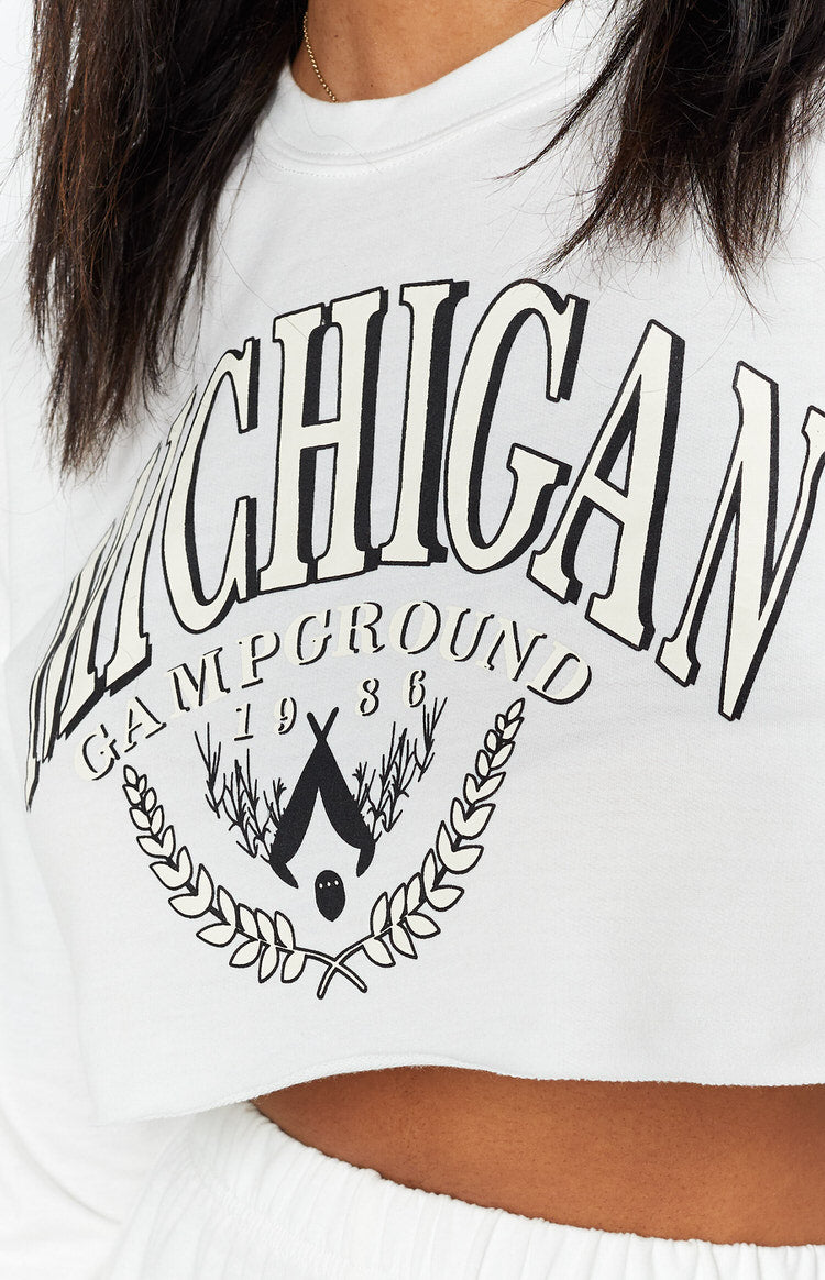 White cropped crew neck top with black and cream Michigan Campground 1986 graphic and raw hem