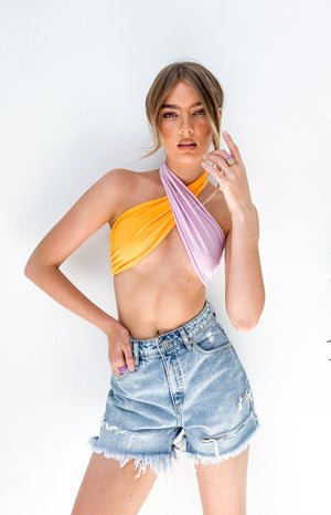 Two-tone orange and lilac wrap-around halter neck crop top