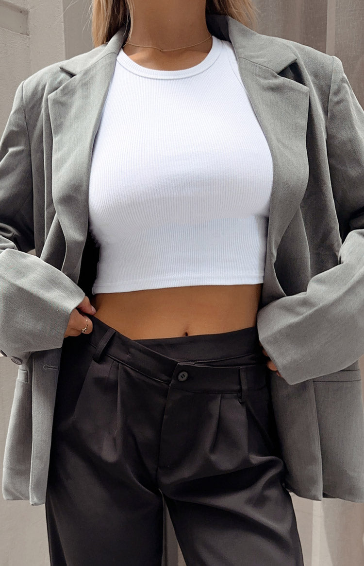 White ribbed knit tank top with a round neckline and cropped fit