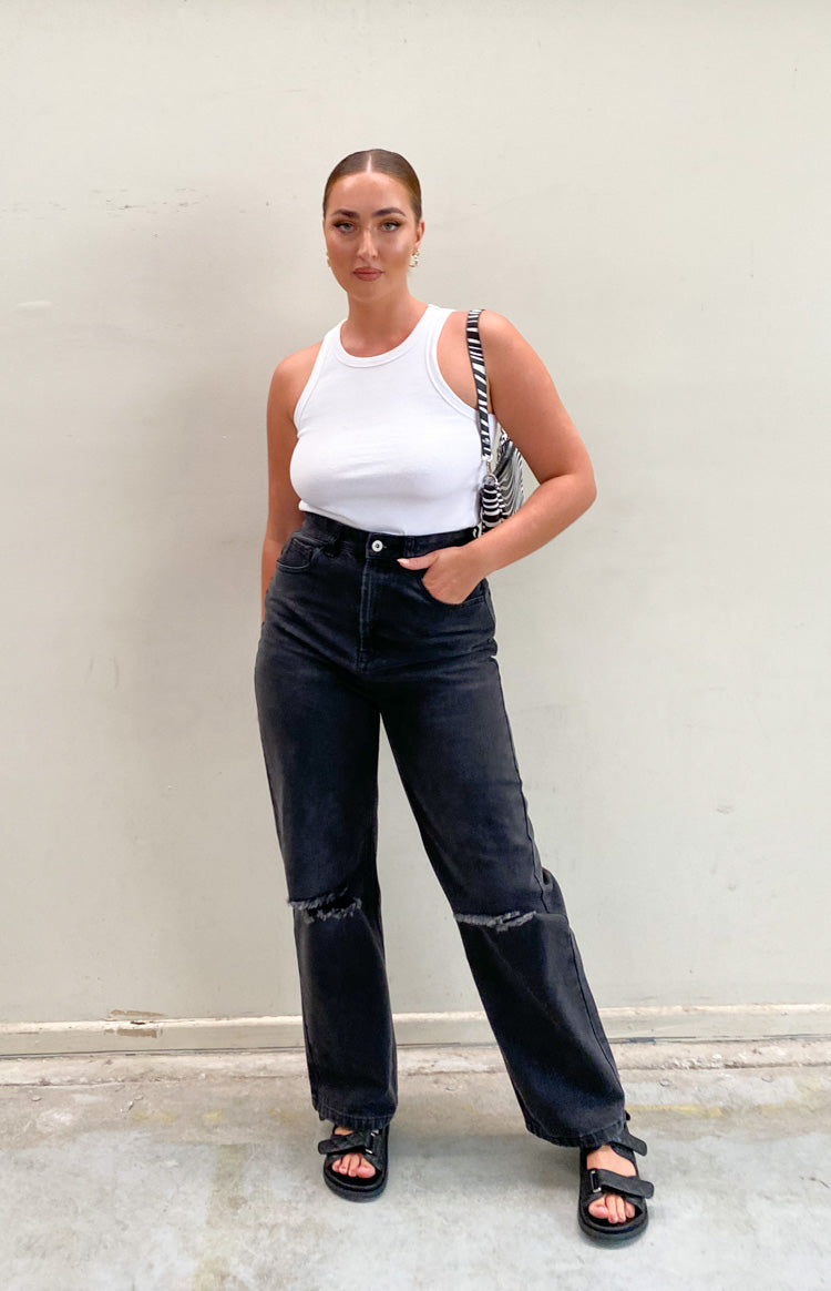 Faded black wide leg jeans with a high waist and ripped knee details