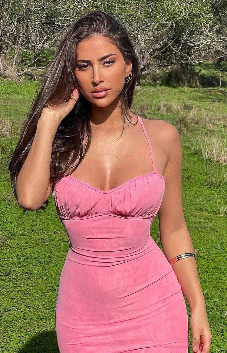 Close-up of the pink maxi dress showing the sweetheart neckline with ruched bust and halter straps