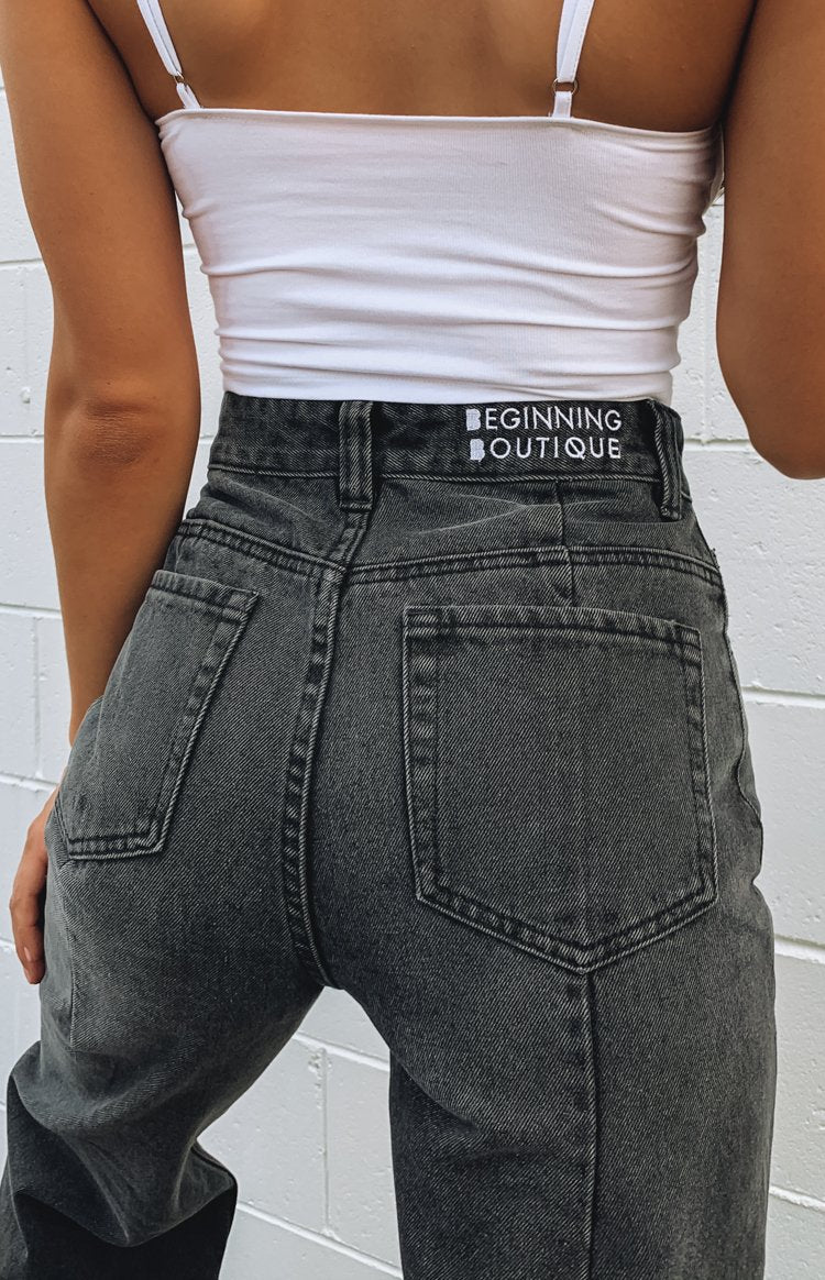 High-waisted black wash wide leg jeans with two back pockets and white Beginning Boutique label