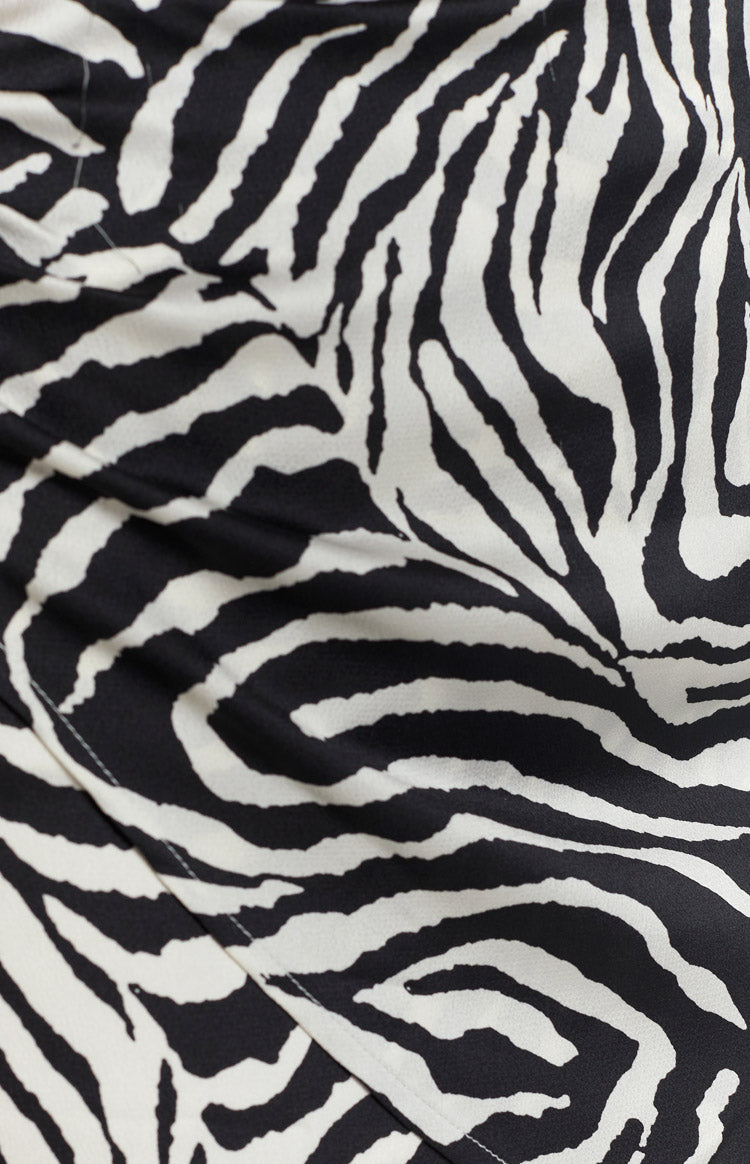 Black and white zebra print fabric of the wrap skirt, showing flowing lines and soft texture
