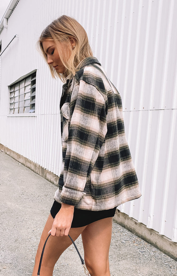 Black, beige, and olive check fleece jacket with a collared neckline, long sleeves, and chest pockets