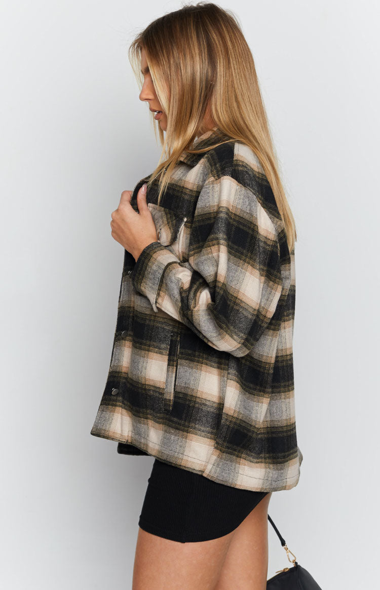 Oversized black, beige, and olive green plaid fleece jacket with side pockets and a relaxed fit