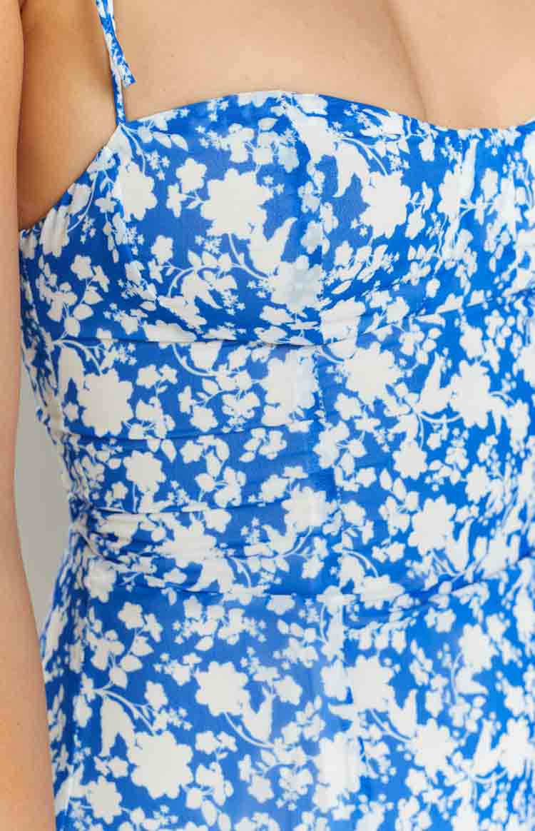 Close-up of the blue floral print mini dress bodice with ruched detailing and thin spaghetti straps