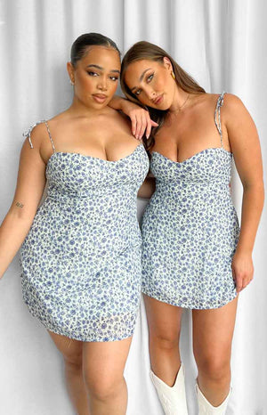 Blue floral mini dress with a fitted silhouette, sweetheart neckline, and adjustable tie straps