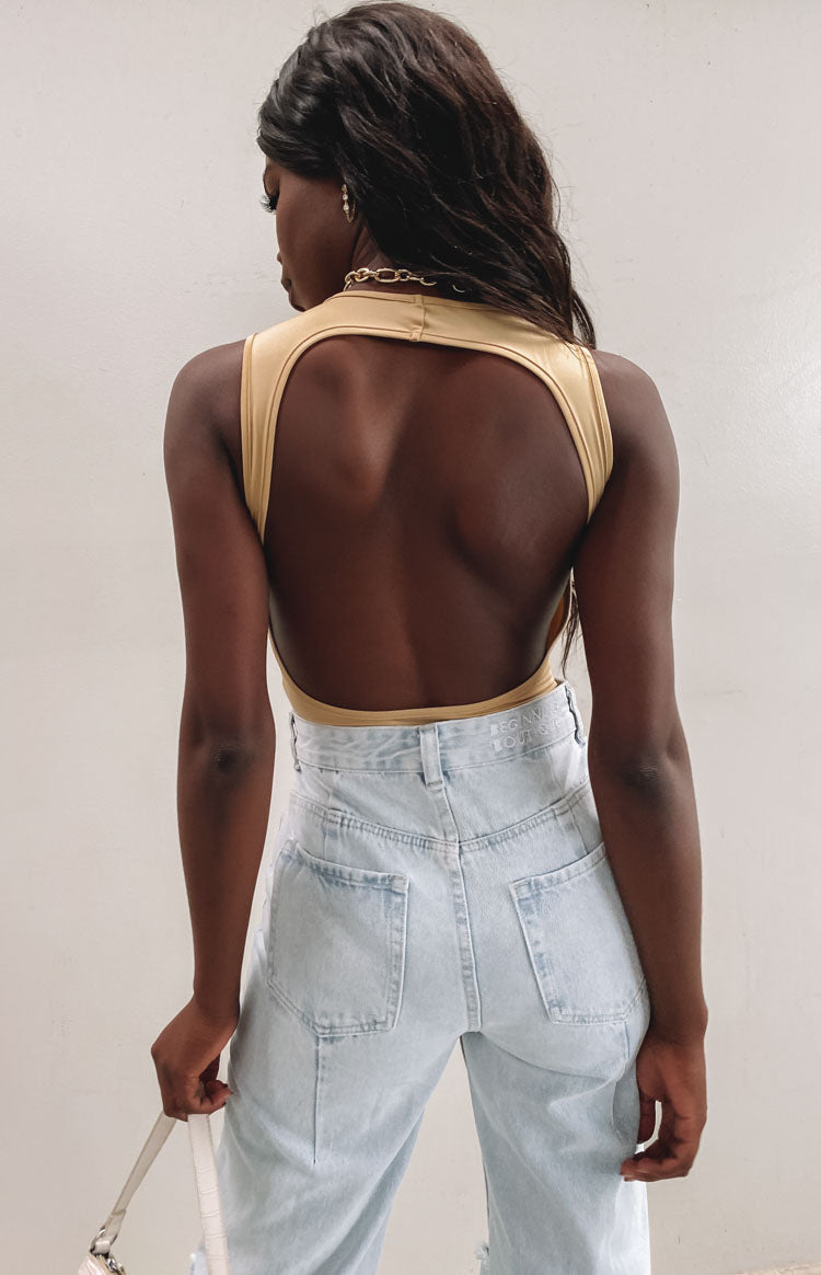 Beige jersey bodysuit with a high neck and large open back cutout