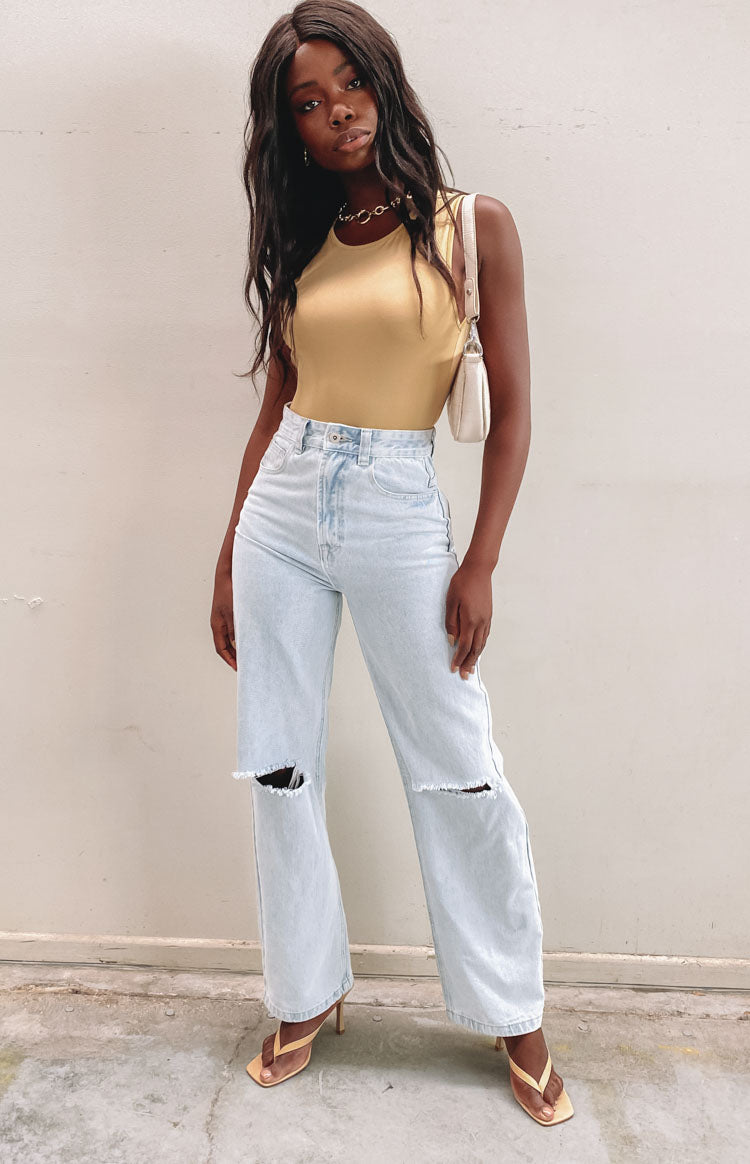 Beige jersey bodysuit with a round neckline and sleeveless design