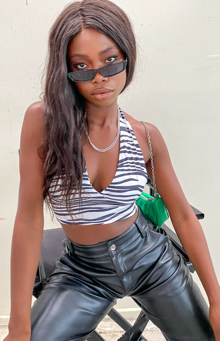 Fitted black and white zebra print crop top with a V-neck and halter neck straps