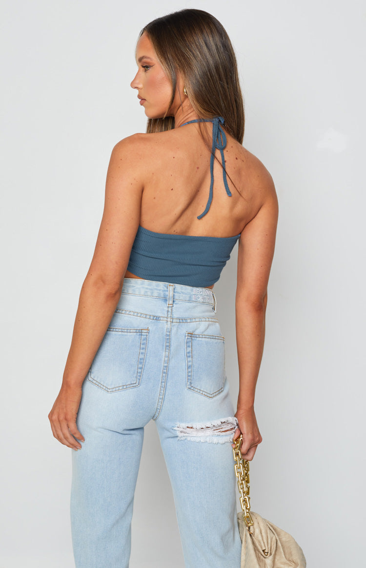 Rear view of the blue ribbed halter top showing the tie-back straps and open back