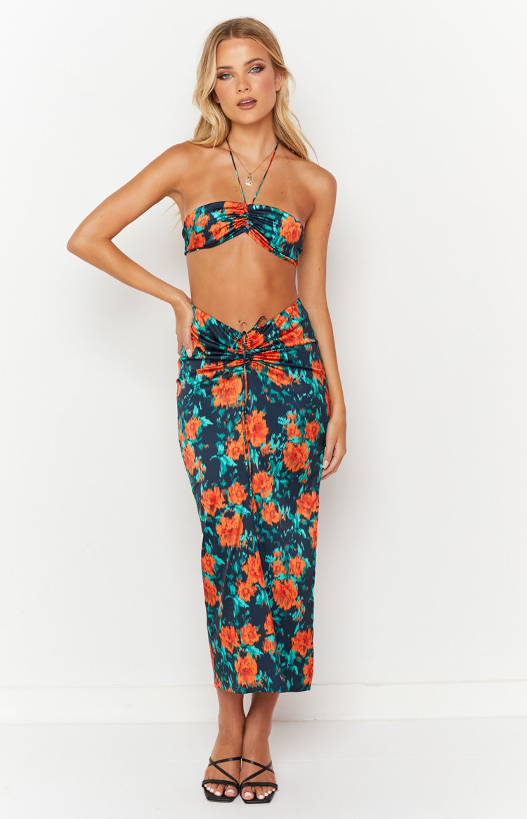 Maxi skirt with a dark base, vibrant orange floral print, and a central ruched drawstring detail