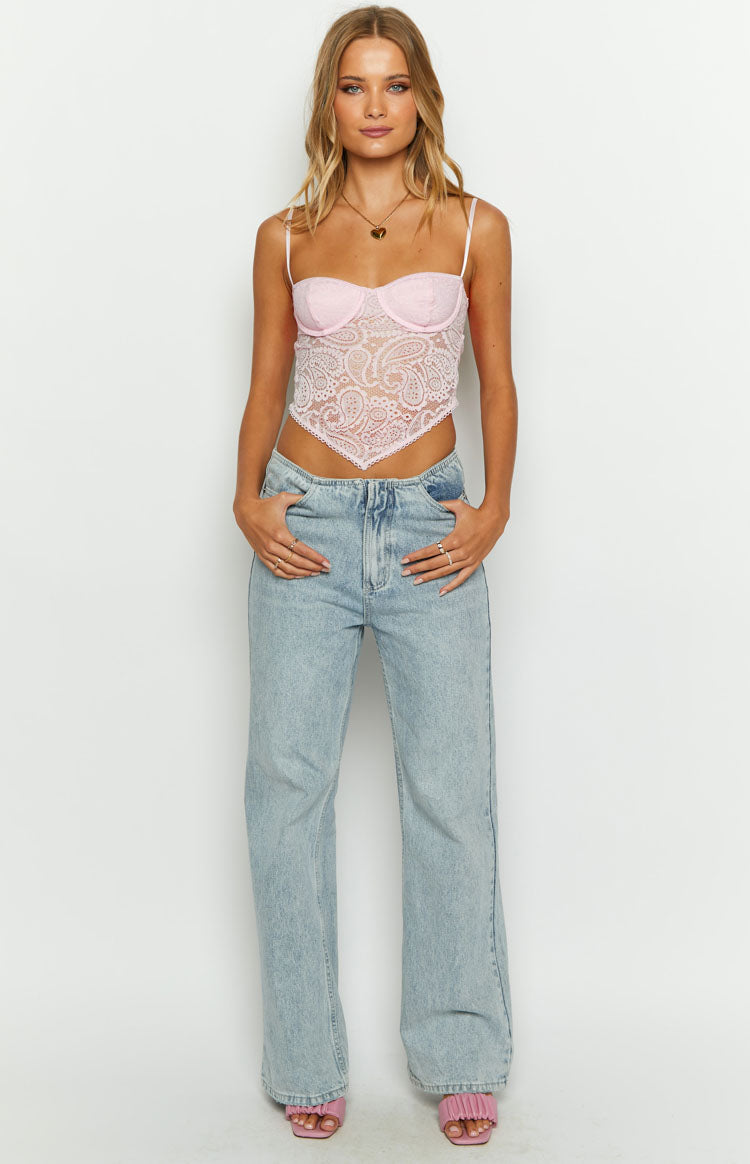 Front view of the pink lace bustier top with a delicate paisley pattern and pointed handkerchief hem