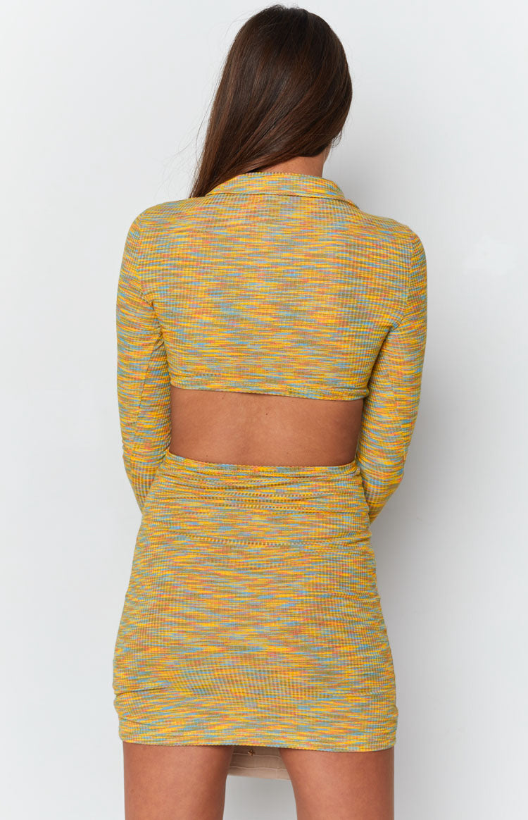 Fitted yellow, orange, blue variegated knit mini dress with a collared back, long sleeves, and wide cutout
