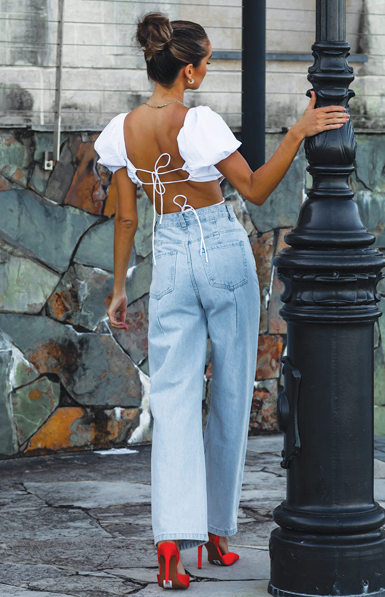 Pale blue wide leg jeans with a relaxed fit, back pockets, and vertical seam detail