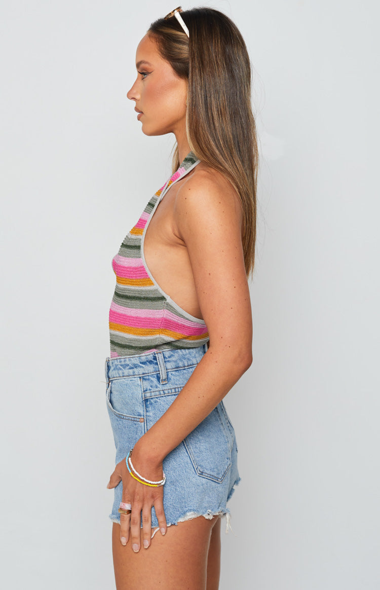 Side view of the multi-coloured striped knit halter top showing the deep armhole cut