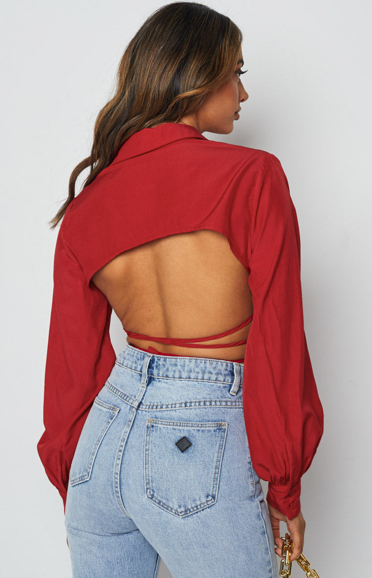 Rear view of a red long sleeve crop top with an open back and tie-up straps