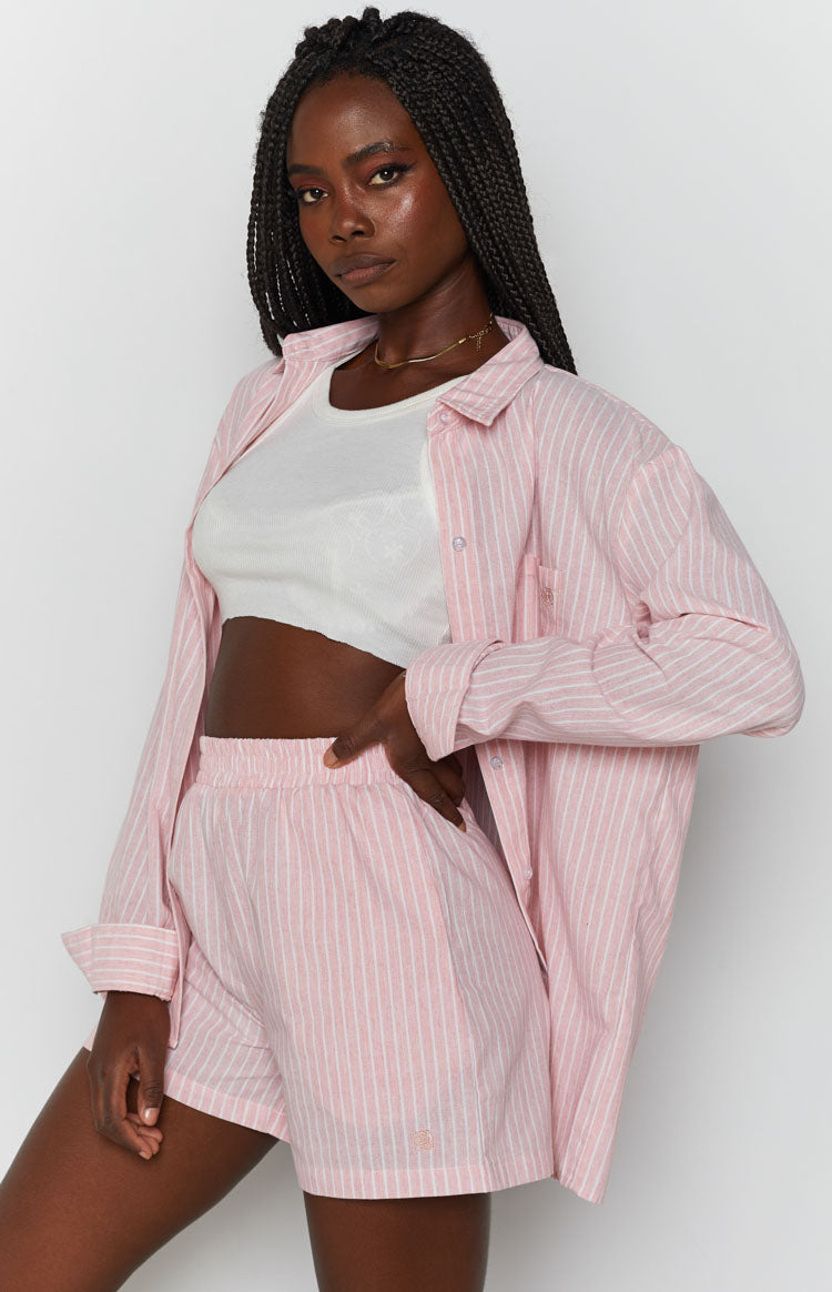 Pink pinstripe shorts with an elasticated high waist and relaxed fit, made from textured fabric