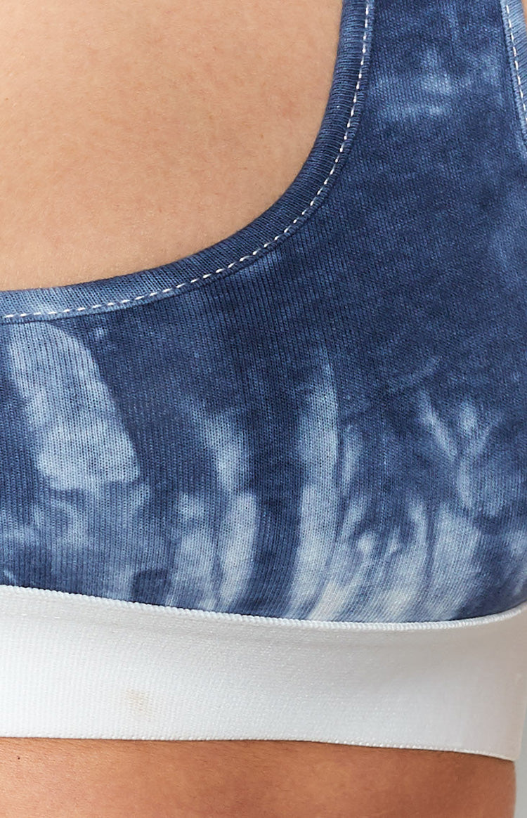 Blue and white tie-dye crop top with white contrast stitching on the strap and a wide white elastic band