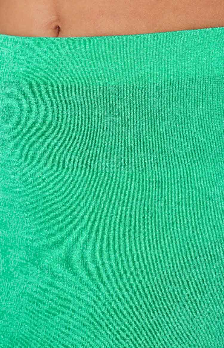 Close-up of the green maxi skirt showing the fine ribbed knit texture and flat waistband
