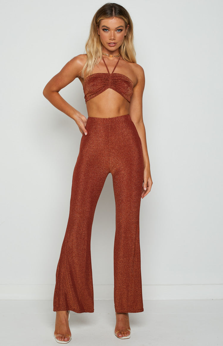 Front view of a rust shimmering bandeau halter top with a ruched front and thin neck straps