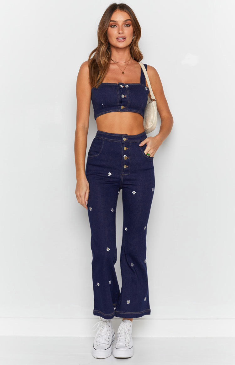 Indigo denim square neck crop top with thick straps, white daisy embroidery, and button-front