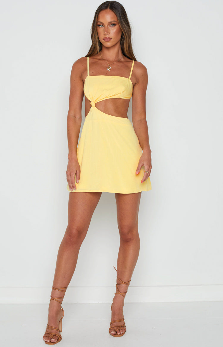 Yellow mini dress with a square neckline, thin straps, twisted knot detail, and side waist cutouts