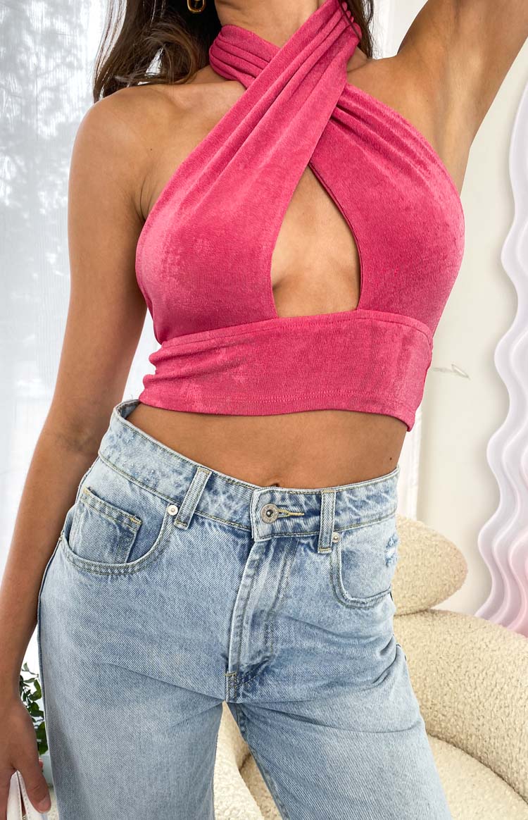 Close-up of the pink textured cross-neck top with a front cutout detail and cropped hem