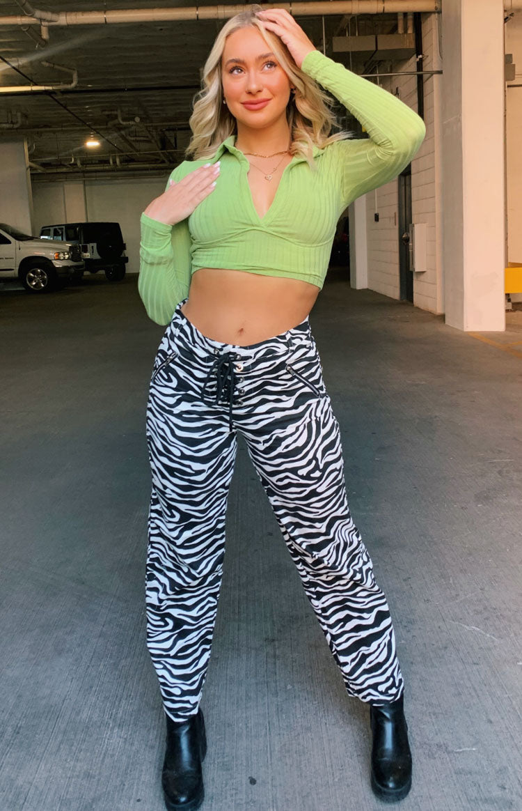 Low-rise black and white zebra print pants with a lace-up front and side zipper pockets