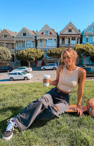 Distressed black wash wide leg jeans with large rips on the knees and thighs