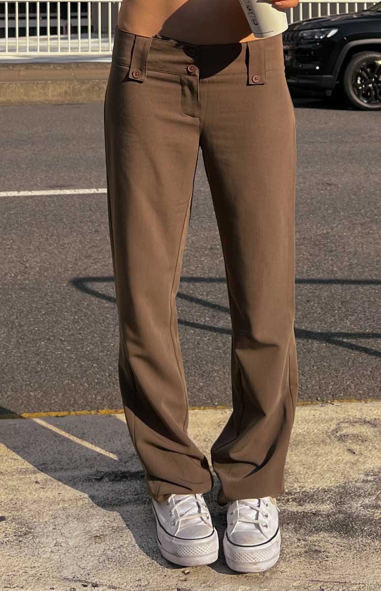 Taupe low waist pants with buttoned waistband tabs and a relaxed straight leg silhouette
