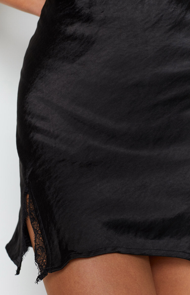 Black satin-look mini skirt with a side slit revealing delicate black lace trim