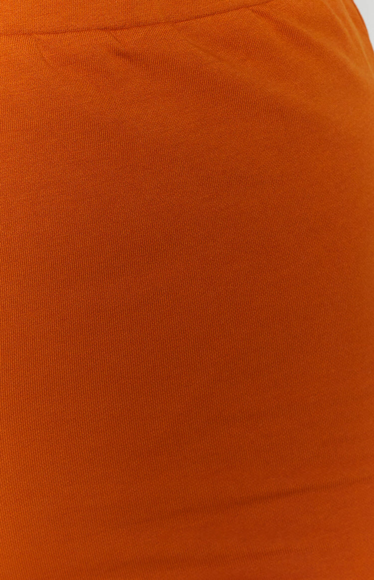 Close up of the tan ribbed knit fabric of the shorts, showing its fine vertical texture