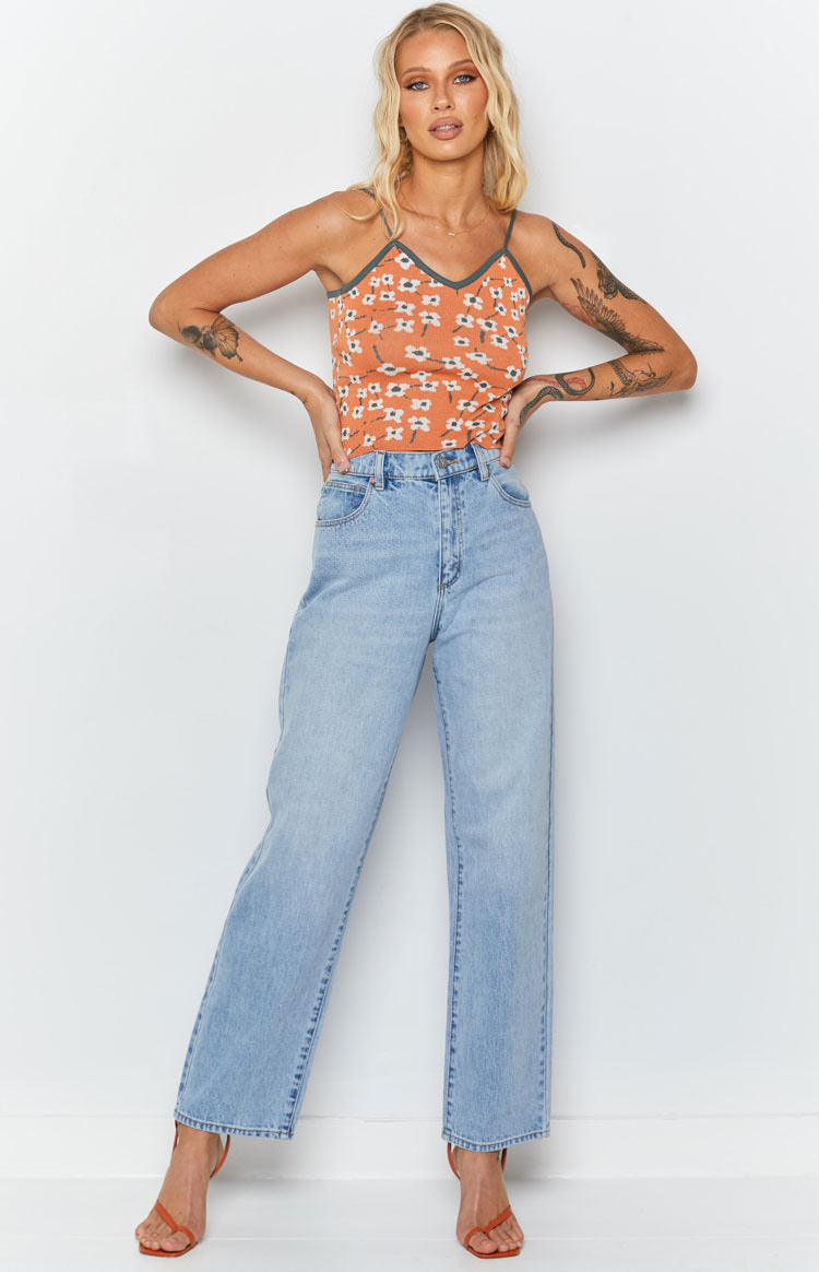 Orange ribbed knit crop top with white blossom print, V-neckline and contrasting dark green trim