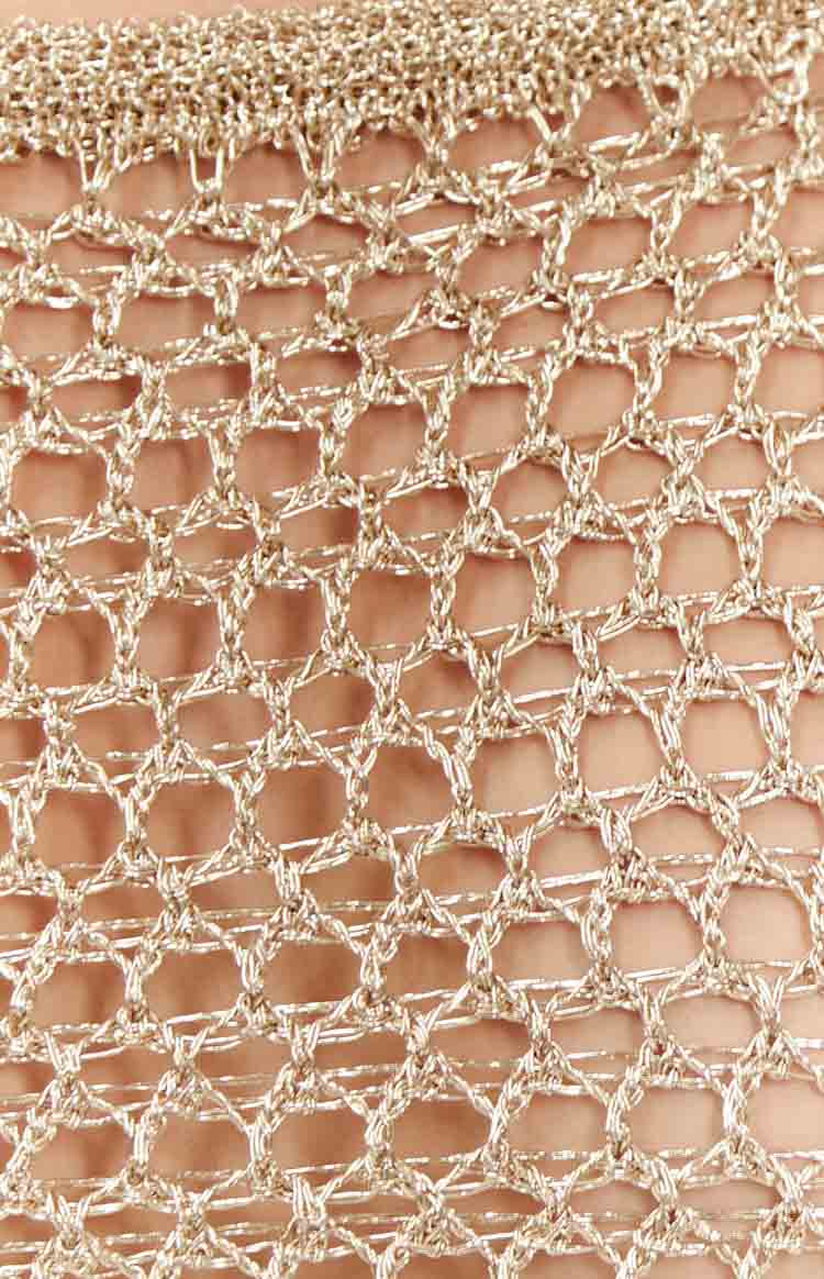 Detail shot of the gold metallic knit fabric with an open, diamond-shaped mesh pattern