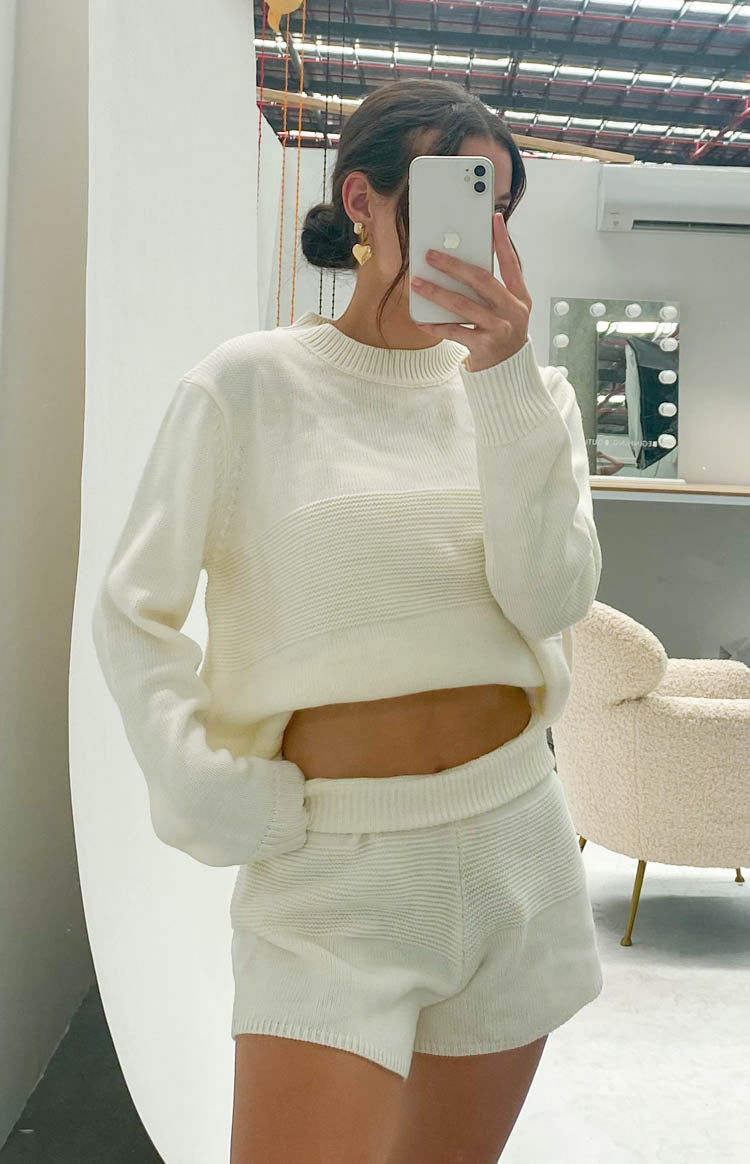 Cropped cream long sleeve knit top with a crew neck and horizontal ribbed knit detail