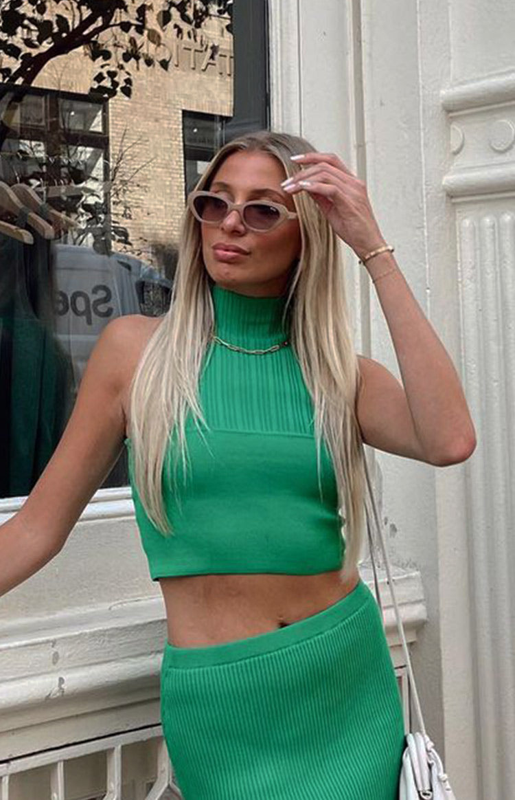 Close-up of a green knit tank with a ribbed mock neck and smooth cropped body