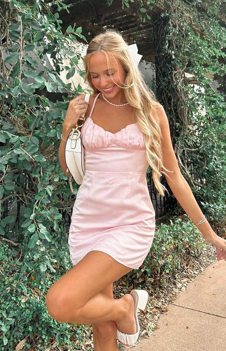 Pink satin mini dress with a ruched sweetheart neckline and gathered skirt